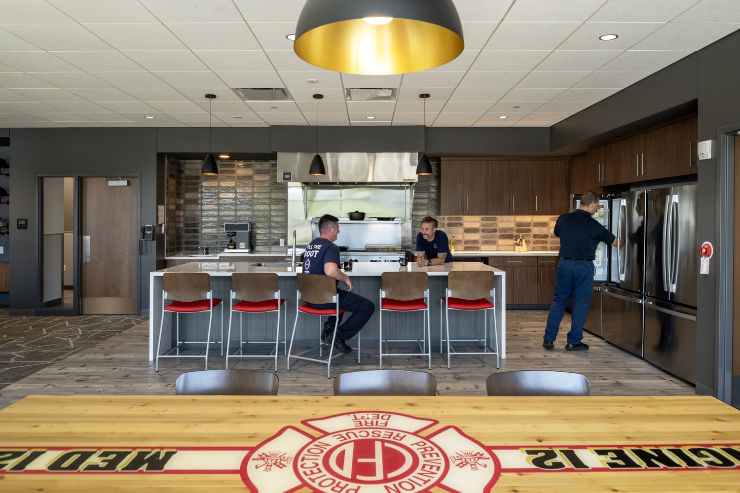firefighters talking in newly built fire station kitchen